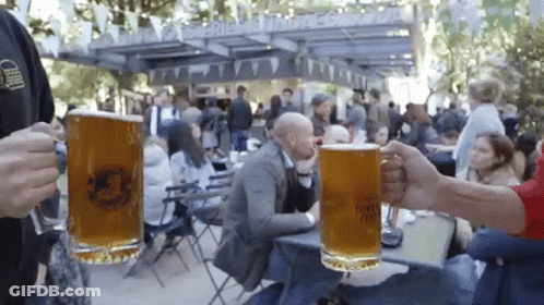 Two Mugs Of Beer Held Up At Beer Festival GIF