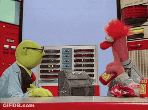 Two Muppets Are Sitting At A Table With A Machine That Says Computer Data Store GIF