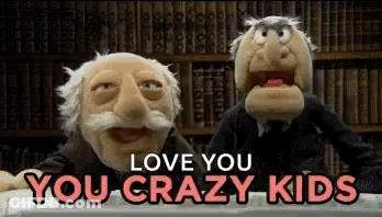 Two Muppets Are Sitting Next To Each Other In A Library . GIF
