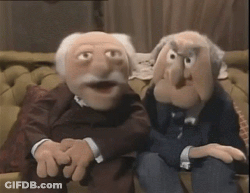 Two Muppets Are Sitting Next To Each Other On A Couch In A Living Room . GIF