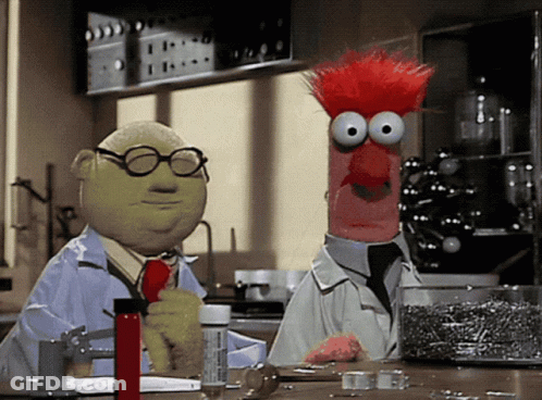 Two Muppets Are Standing Next To Each Other In A Lab And One Has Glasses On GIF