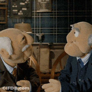 Two Muppets In Suits Talking GIF