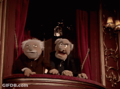 Two Muppets Sitting On Balcony In Dark Room GIF