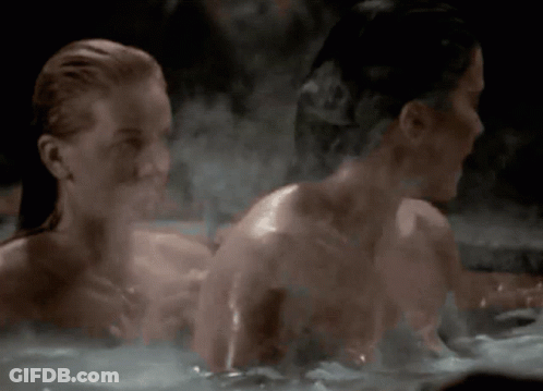 Two Naked Women Are Taking A Bath Together GIF