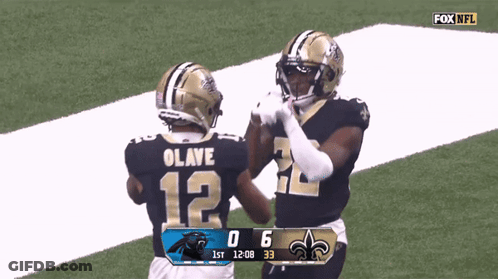 Two New Orleans Saints Football Players High Five Each Other On The Field GIF