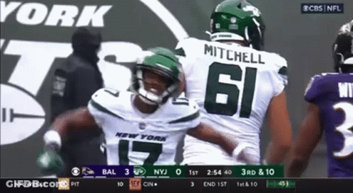 Two New York Jets Football Players Hugging On Field GIF