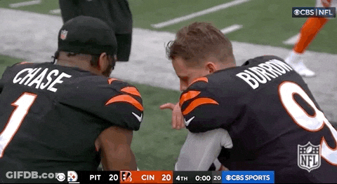 Two NFL Players Chase And Burrom Kneeling On Field GIF