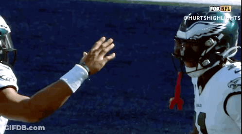 Two NFL Players High Five GIF