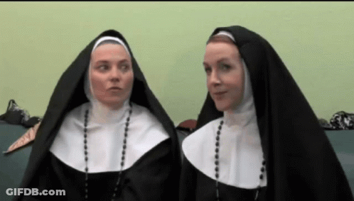 Two Nuns Sitting On Green Couch GIF