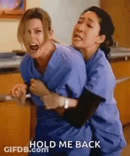 Two Nurses Are Hugging Each Other In A Hospital Room And Screaming . GIF