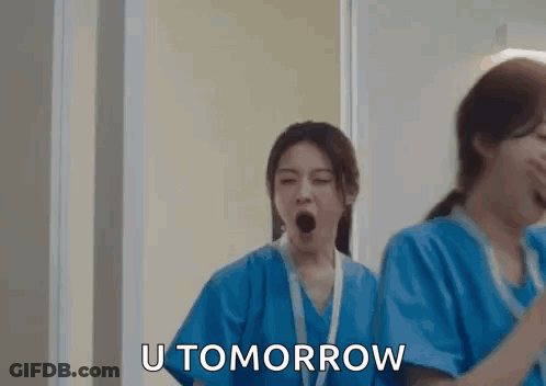 Two Nurses Yawning In Hallway While Another Says U Tomorrow GIF
