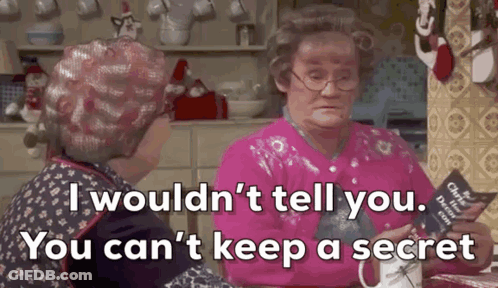 Two Older Women Are Sitting At A Table In A Kitchen Talking To Each Other And One Of Them Is Holding A Book . GIF