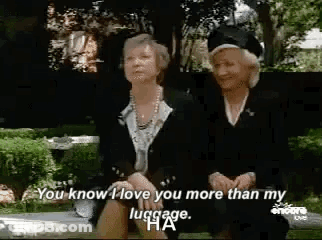 Two Older Women Sitting On Bench Talking GIF