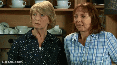 Two Older Women Standing By Coffee Machine GIF