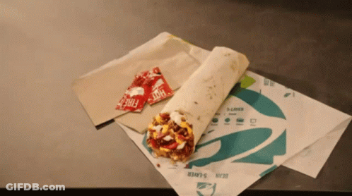 Two Packets Of Hot Sauce Sit Next To A Taco Bell Burrito GIF
