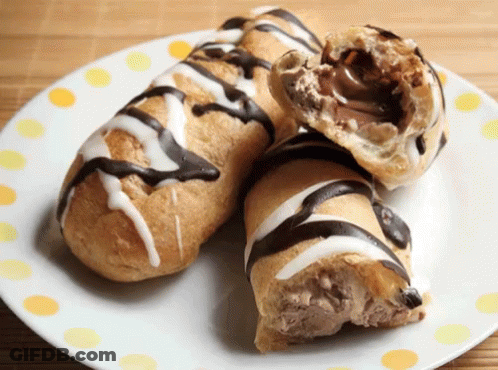 Two Pastry Rolls With Chocolate And Icing On A Plate GIF
