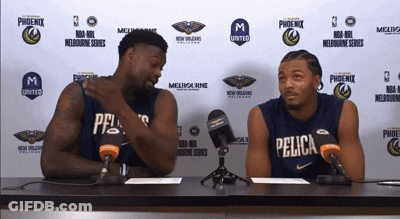 Two Pelicans Players Are Sitting At A Table With Microphones GIF
