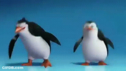 Two Penguins Are Standing Next To Each Other On A Blue Surface GIF