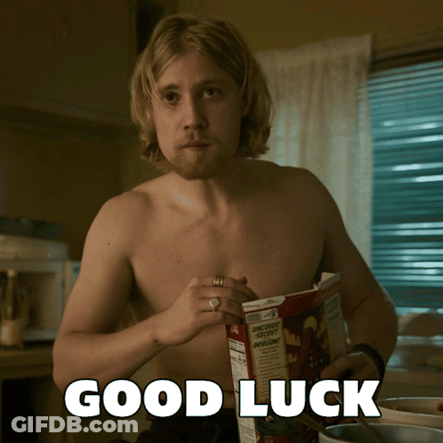 Two Penguins Holding Four Leaf Clovers Saying Good Luck GIF