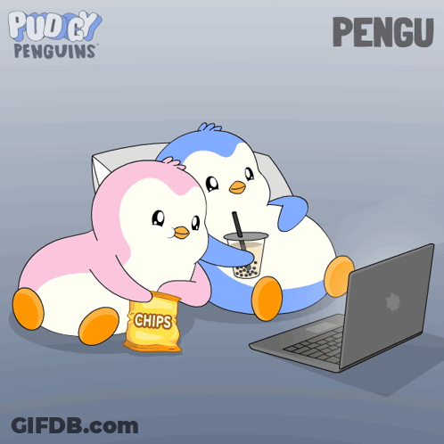 Two Penguins Sitting Next To Each Other With A Bag Of Chips In Front Of A Laptop GIF