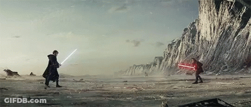Two People Are Fighting With Lightsabers In The Desert . GIF
