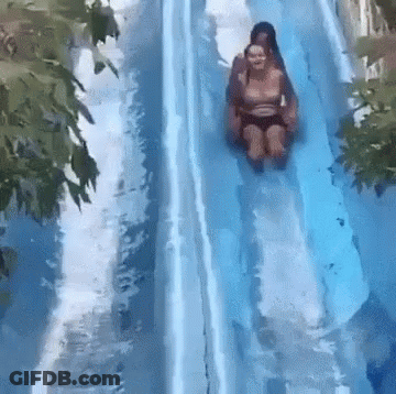 Two People Are Riding Down A Water Slide At A Water Park GIF