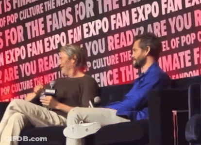 Two People Are Sitting In Front Of A Wall That Says " Are You Ready " On It GIF