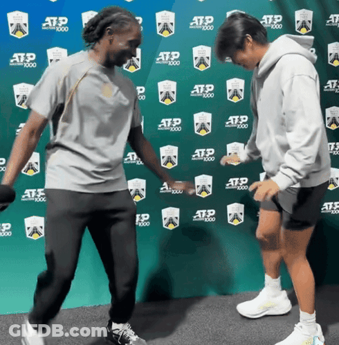 Two People Dancing In Front Of ATP 1000 Wall GIF