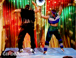 Two People Dancing In Front Of Disco Ball GIF