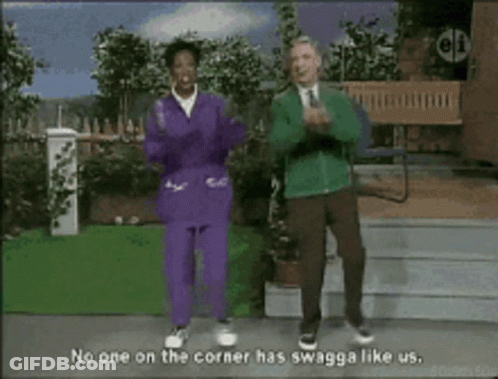 Two People Dancing In Front Of No One On The Corner Has Swagga Like Us Sign GIF
