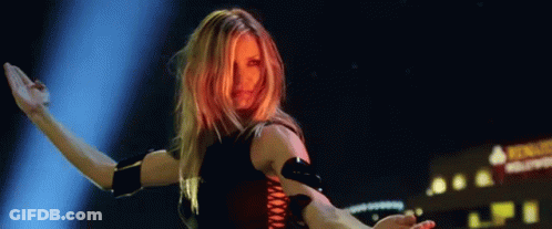 Two People Dancing On Stage In Blue Light GIF