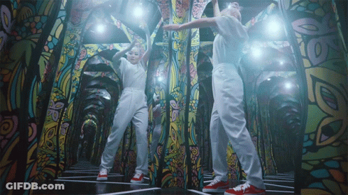 Two People Dancing With Stained Glass Wall GIF