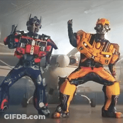 Two People Dressed As Transformers Standing Together GIF