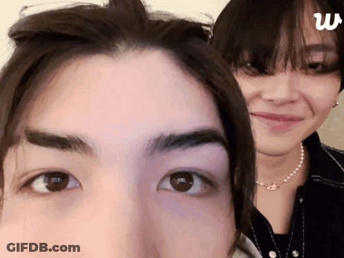 Two People Faces With Letter W GIF