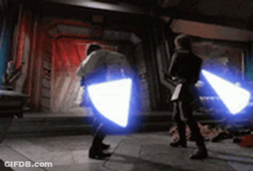 Two People Fighting With Lightsabers GIF