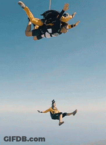 Two People Flying With Parachute GIF