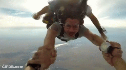 Two People Holding Hands In Air GIF