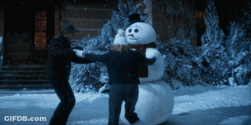 Two People Holding Snowman With Scarf GIF