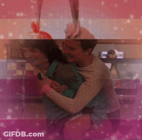 Two People Hugging On Pink Background GIF