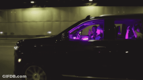 Two People In A Black Suv With Purple Lights On GIF