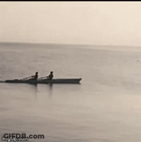 Two People In A Boat In Ocean GIF