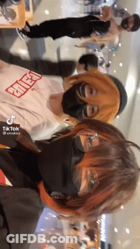 Two People In Masks And Glasses Standing Together GIF