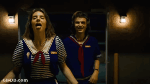 Two People In Sailor Outfits Are Laughing And Spellbooked Is Visible In The Bottom Right Corner GIF