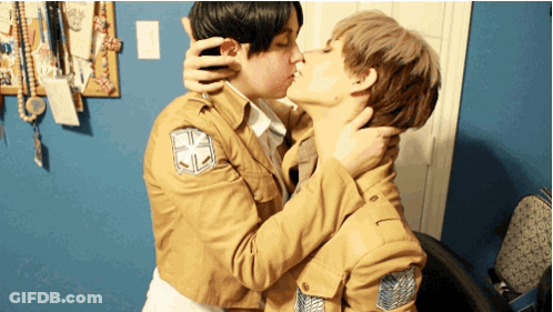 Two People Kissing With One Wearing A Jacket With A Cross On The Sleeve GIF