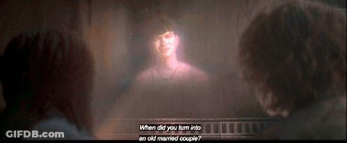 Two People Looking At Projection Of Woman Saying When Did You Turn Into An Old Married Couple GIF