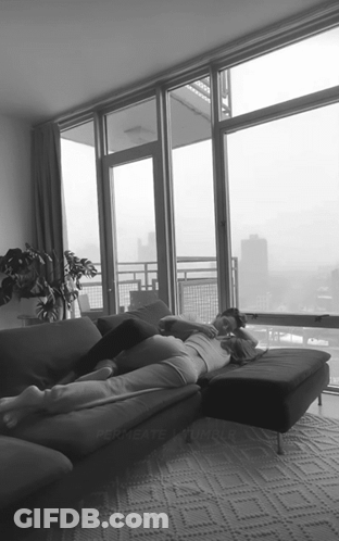 Two People Lying On Couch GIF