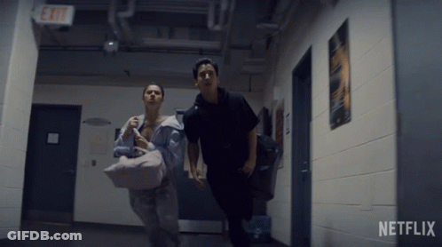Two People Running In Hallway With Netflix Logo GIF