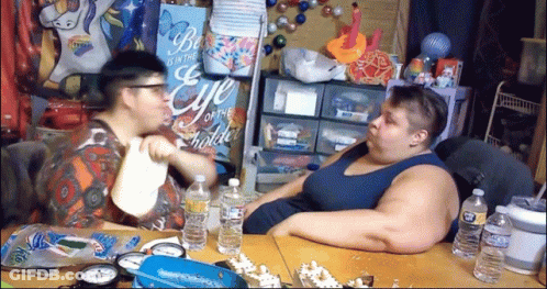Two People Sitting At Be The Eye Of The Beholder Sign GIF