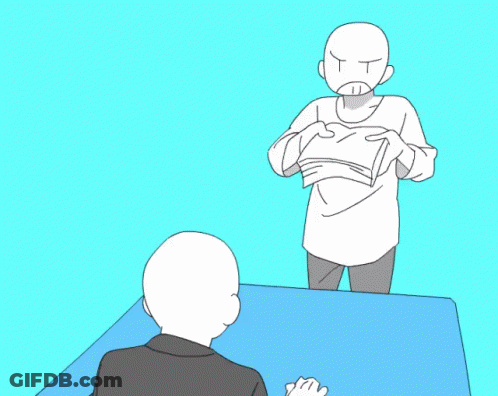 Two People Sitting At Table With Book GIF