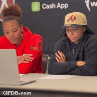 Two People Sitting At Table With Laptop And Cash App Logo GIF